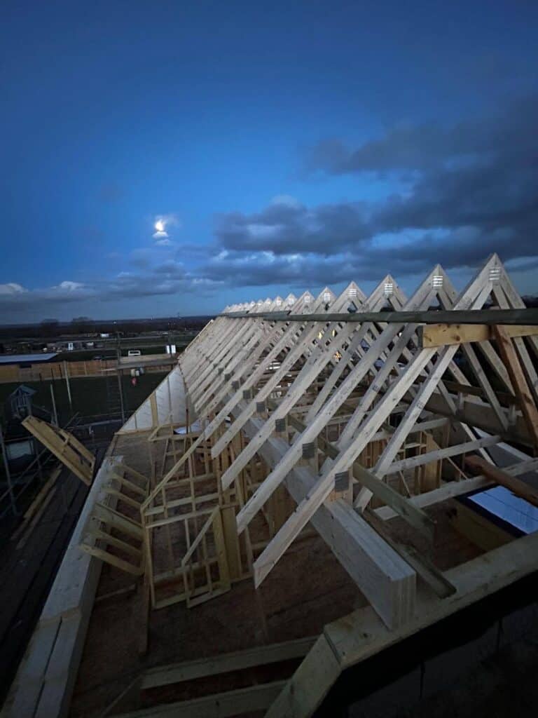 Timber frame building with insulated floors and walls being built