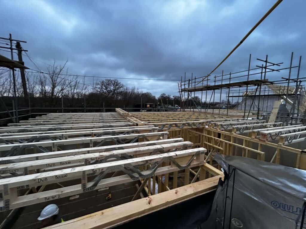 Timber frame building with insulated floors and walls being built