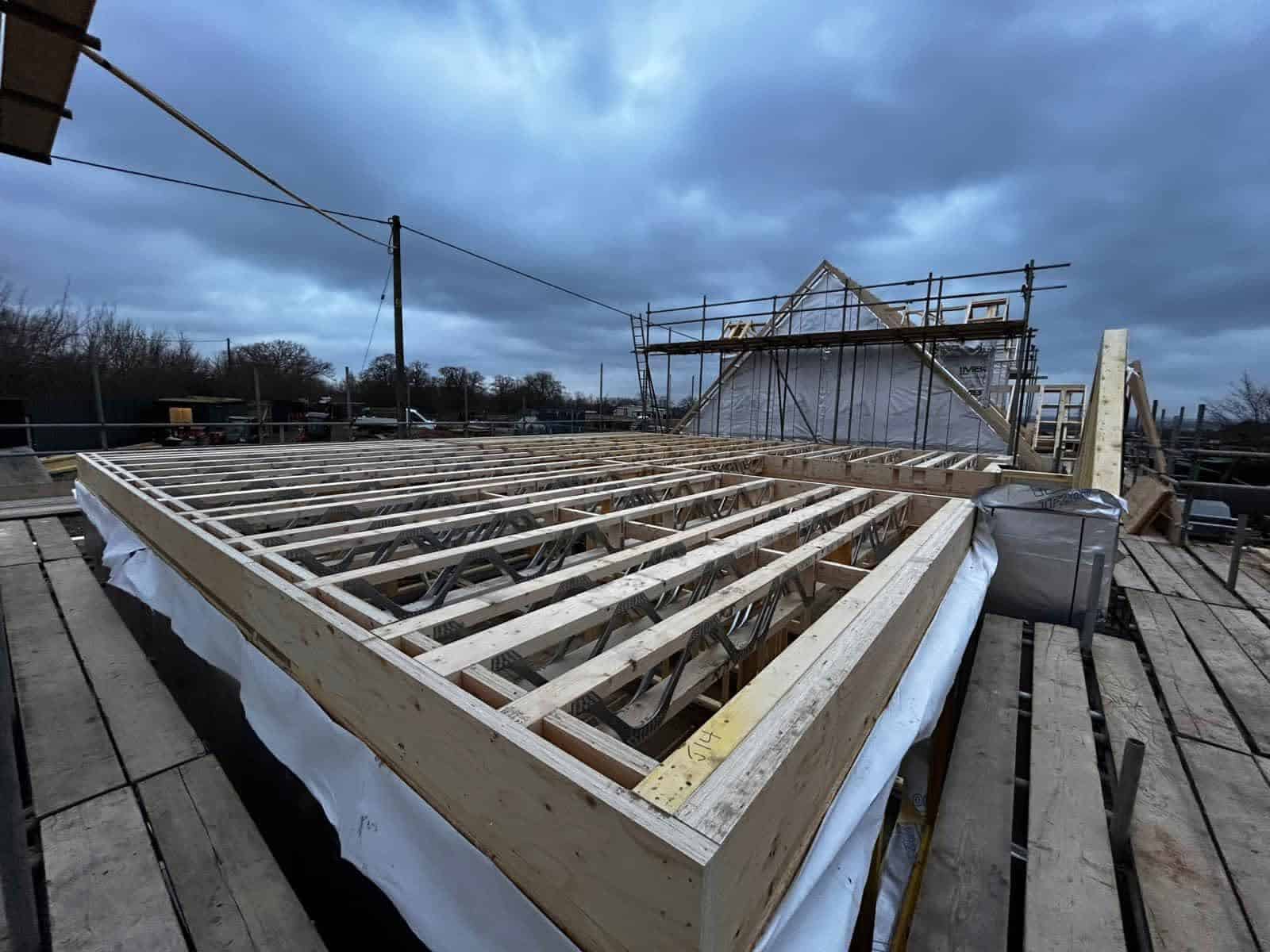 Timber frame building with insulated floors and walls being built