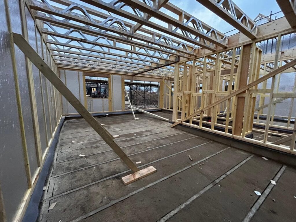 Timber frame building with insulated floors and walls being built