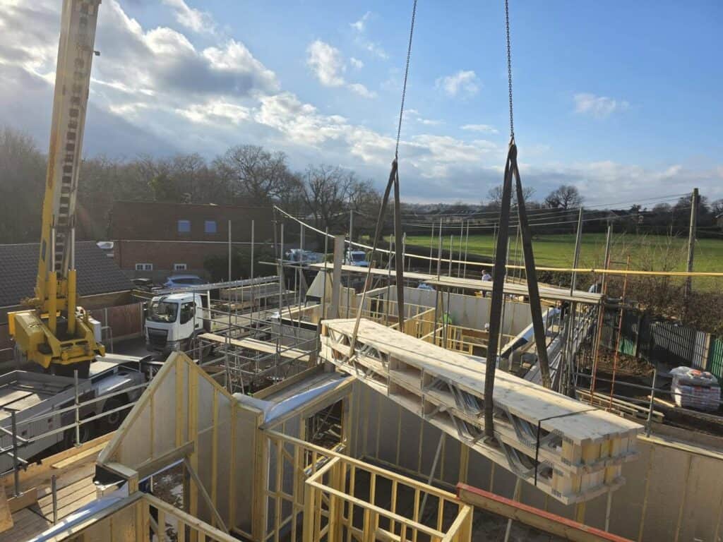 Timber frame building with insulated floors and walls being built