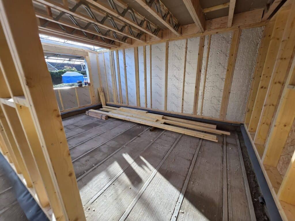 Timber frame building with insulated floors and walls