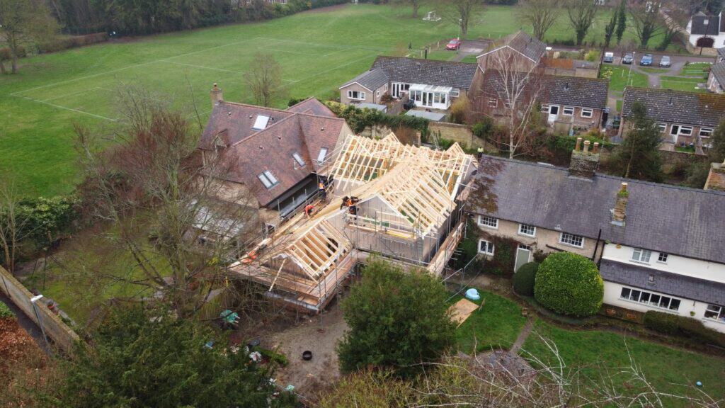 A timber frame building being constructed