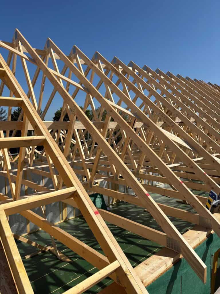 A timber frame building being constructed, truss detail