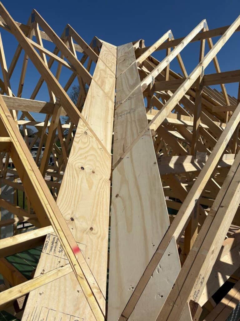 A timber frame building being constructed - valley detail