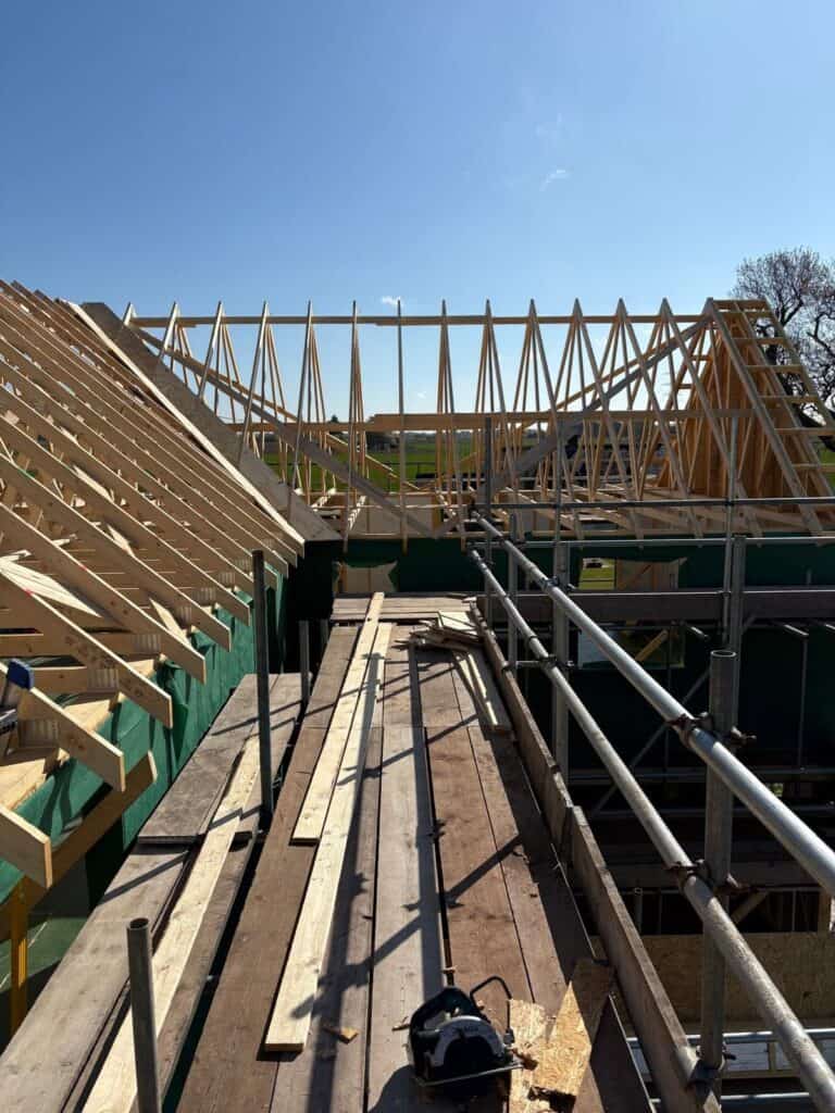 A timber frame building being constructed