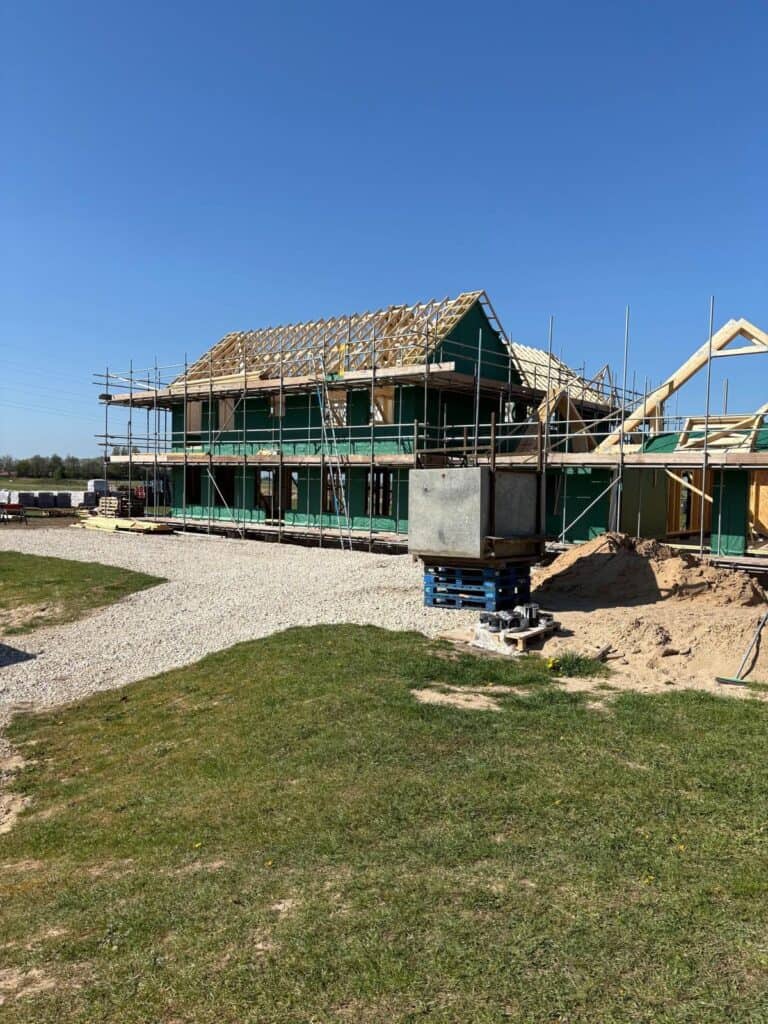 A timber frame building being constructed