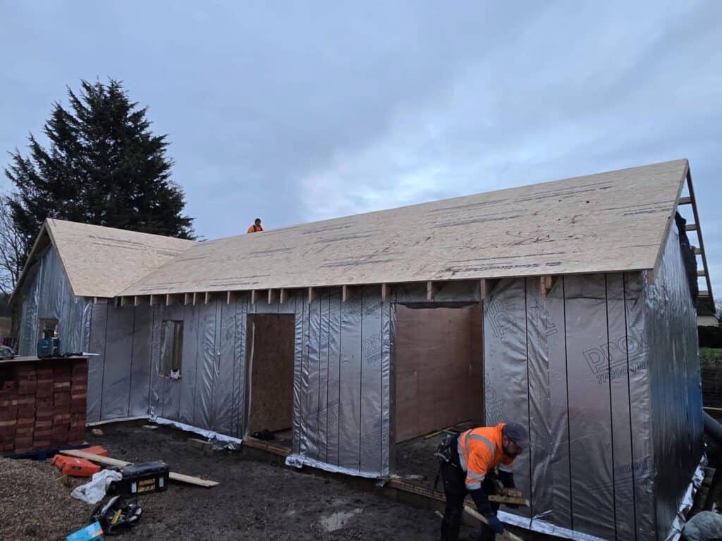 A timber frame bungalow being constructed