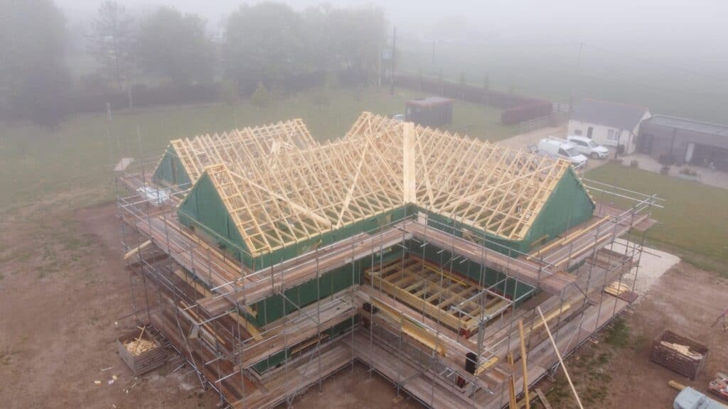 A timber frame building being constructed
