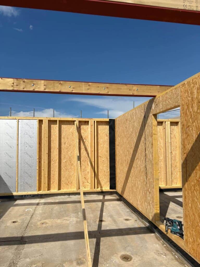Timber frame wall panels being erected